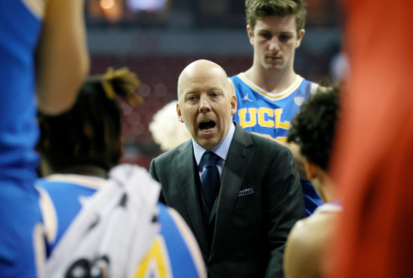LAS VEGAS, NEVADA - NOVEMBER 27: Coach Mick Cronin of the UCLA Bruins talks to his players during a timeout.