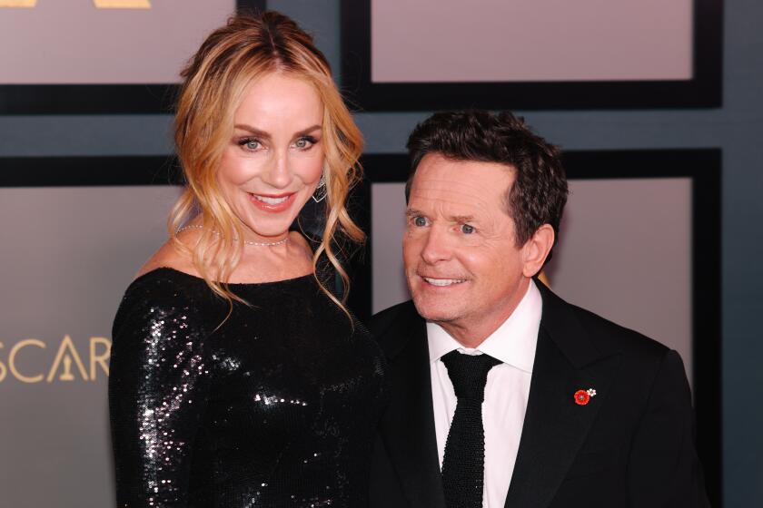 Tracy Pollan and Michael J. Fox walk the red carpet at the Academy of Motion Picture Arts and Sciences Governors Awards.