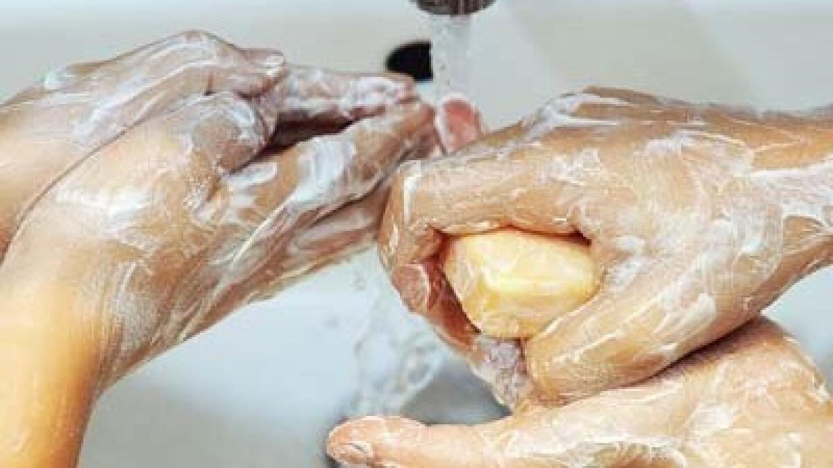 Children wash their hands with soap and water.