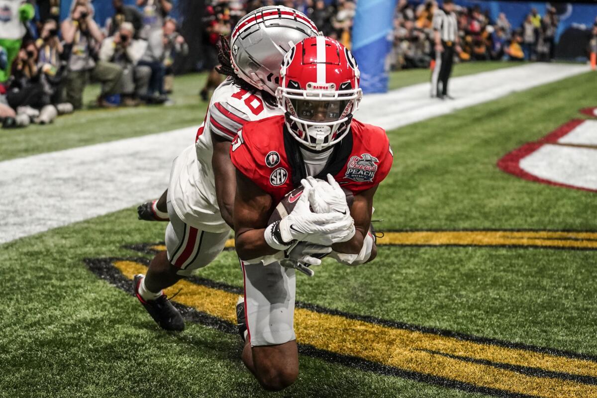 Georgia wide receiver Adonai Mitchell makes a touchdown catch against Ohio State cornerback Denzel Burke.