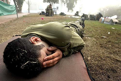 An Israeli soldier sleeps after working the night shift patrolling the Gaza Strip settlement of Morag.