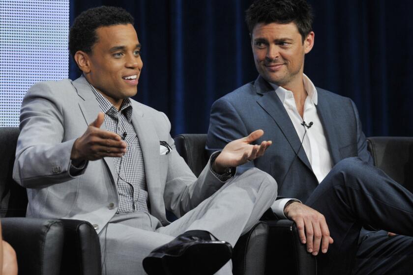 Michael Ealy, left, and Karl Urban, stars of the upcoming Fox series "Almost Human," take part in a panel discussion during the TCA press tour at the Beverly Hilton hotel in Beverly Hills.