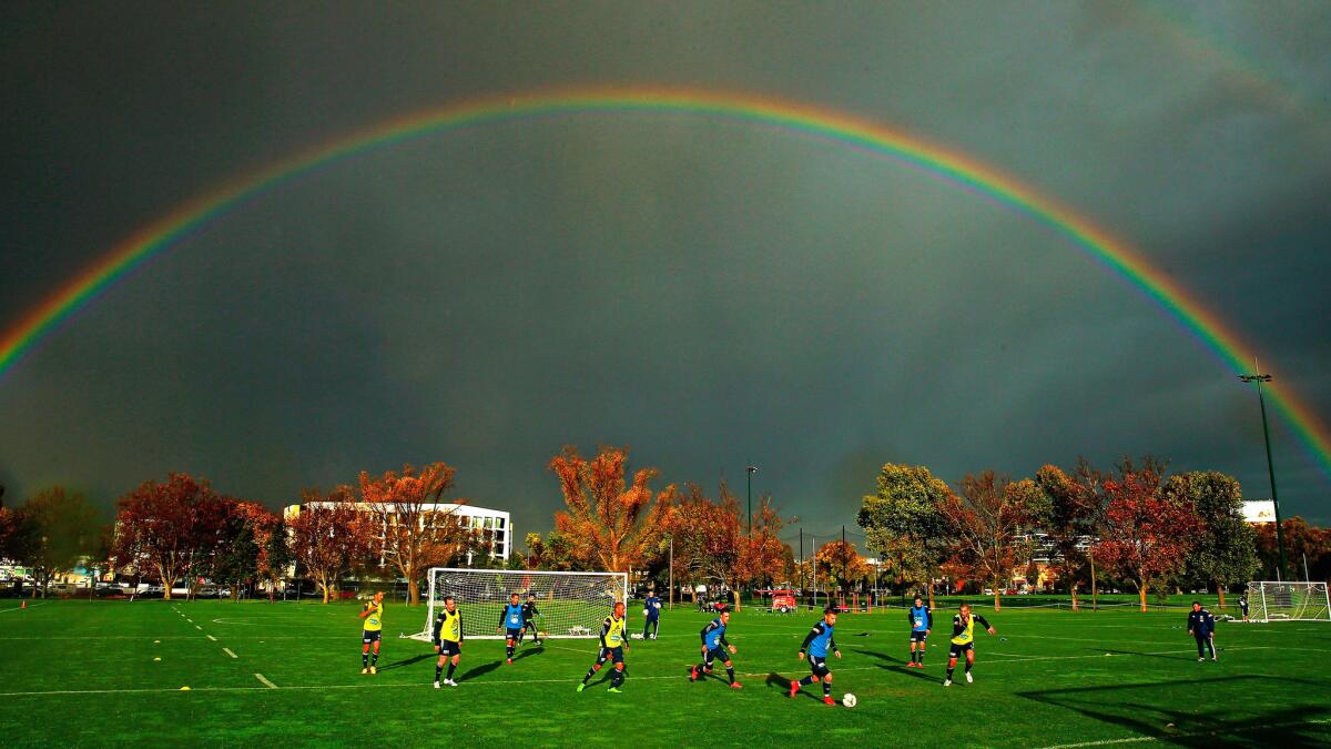 A rainbow forms overhead during a Melbourne Victory A-League training session at Gosch's Paddock on May 12, which is fall in Australia (note the trees). Qantas is offering a $1,250 fare to Melbourne, Sydney or Brisbane.