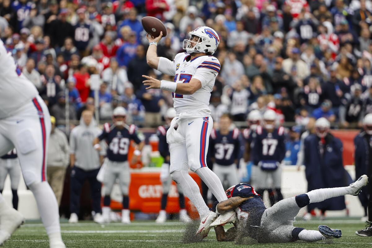Buffalo Bills quarterback Josh Allen gets off a pass under pressure against the New England Patriots.