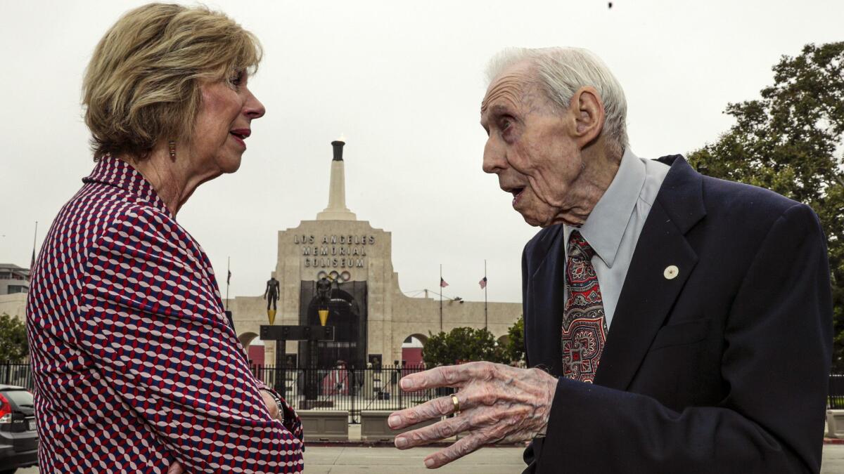 Los Angeles County Supervisor Janice Hahn speaks with Elbert Wilkinson, a WWII veteran, during a ceremony at the Coliseum to commemorate the 75th anniversary of D-Day on June 6.