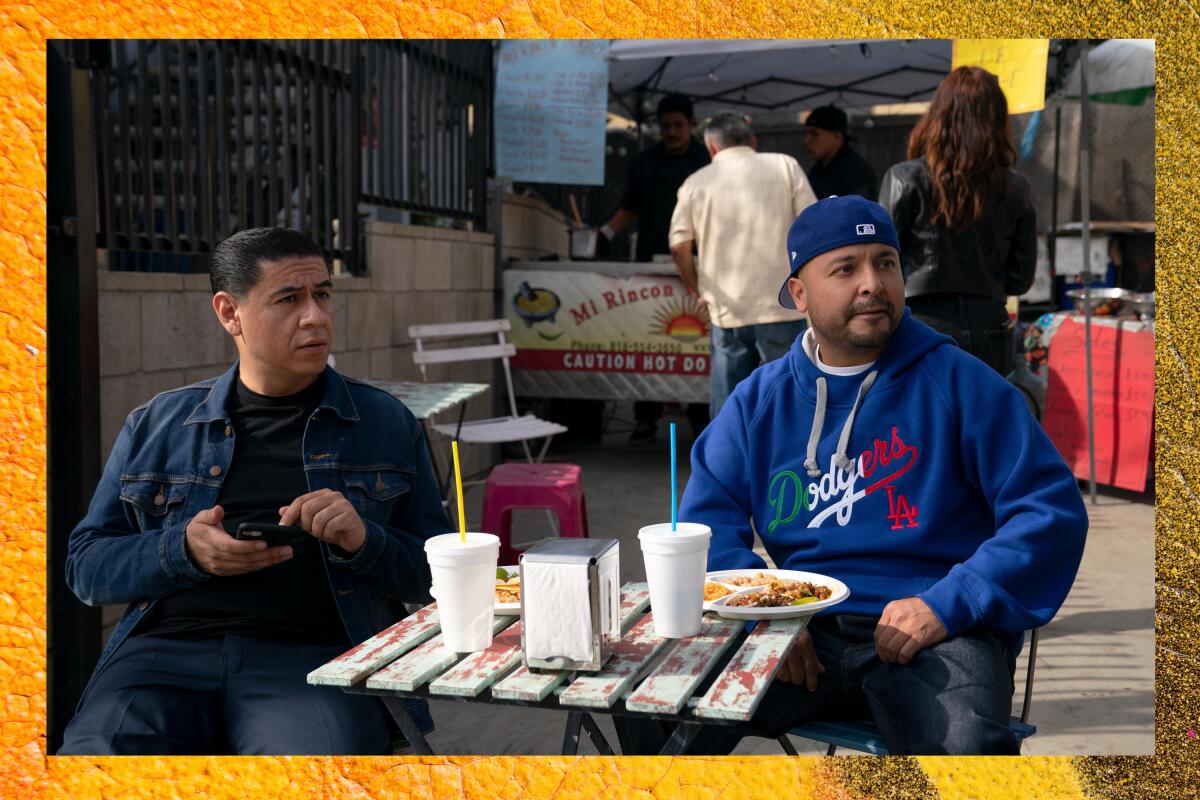 two men sitting at an outdoor restaurant 