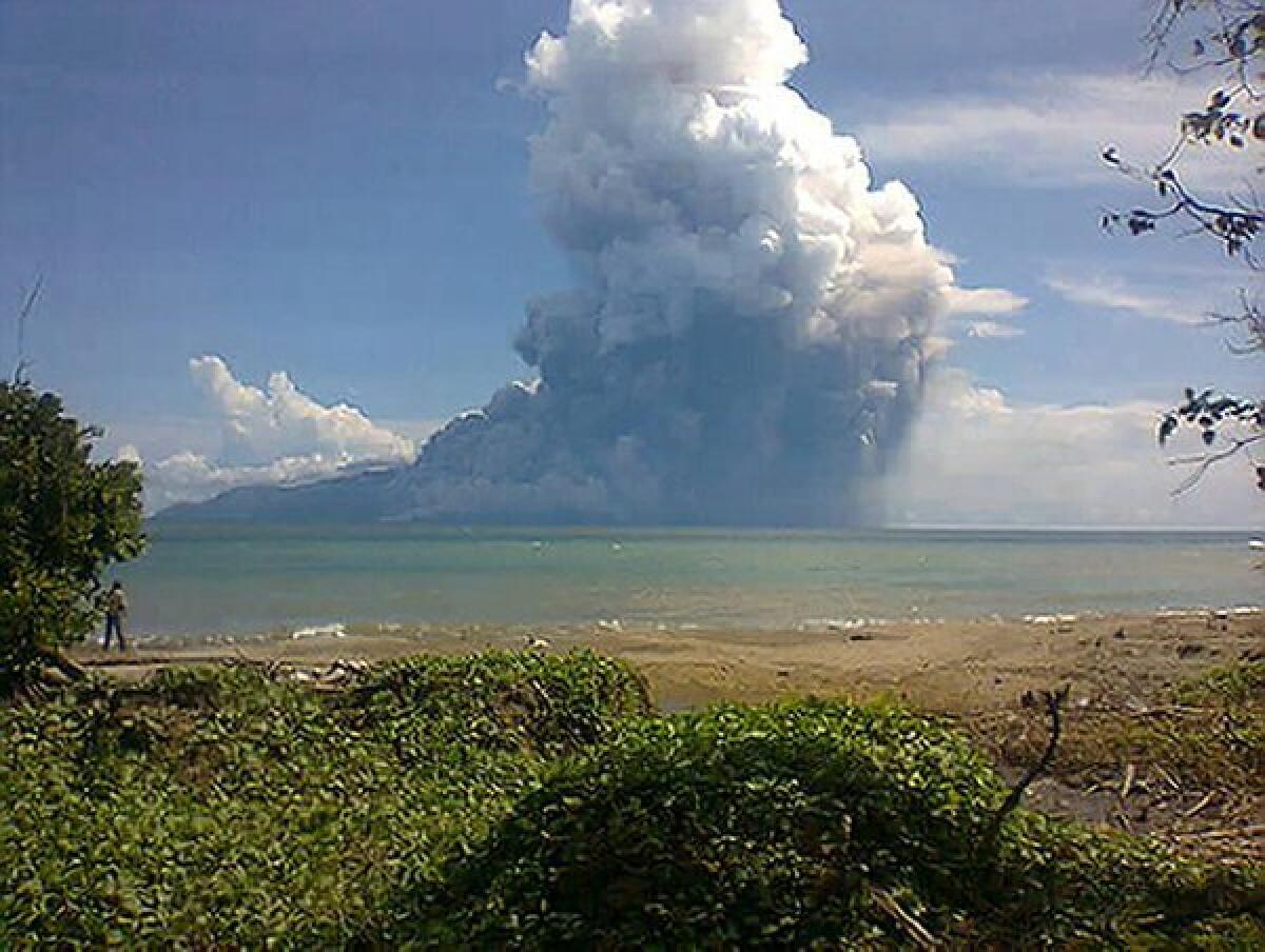 The photo taken from the Maurole district of East Nusa Tenggara province with a phone camera shows Mount Rokatenda volcano sending a huge column of hot ash into the air during an eruption Saturday.