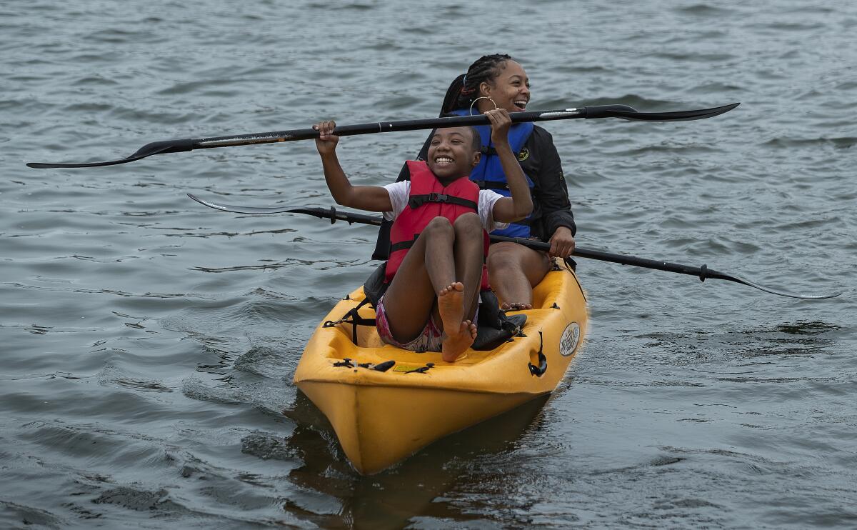 LeLe Jackson, front, and her cousin, Chey Lewis of Los Angeles, enjoy the paddling at Marina del Rey's Mother's Beach.
