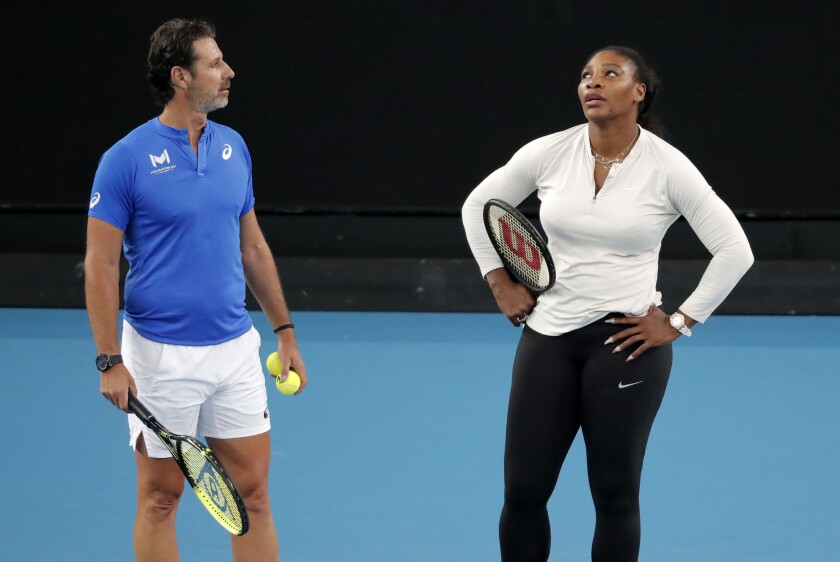 FILE - United States' Serena Williams and her coach Patrick Mouratoglou react during a practice session ahead of the Australian Open tennis championship in Melbourne, Australia, Friday, Jan. 17, 2020. Serena Williams’ coach for a decade, Mouratoglou is going to work with another Grand Slam champion and former No. 1, Simona Halep. Mouratoglou announced his partnership with Halep via social media on Thursday, April 7, 2022, creating a formidable pairing but also raising questions about what this means for the future of Williams as a player. (AP Photo/Lee Jin-man, File)