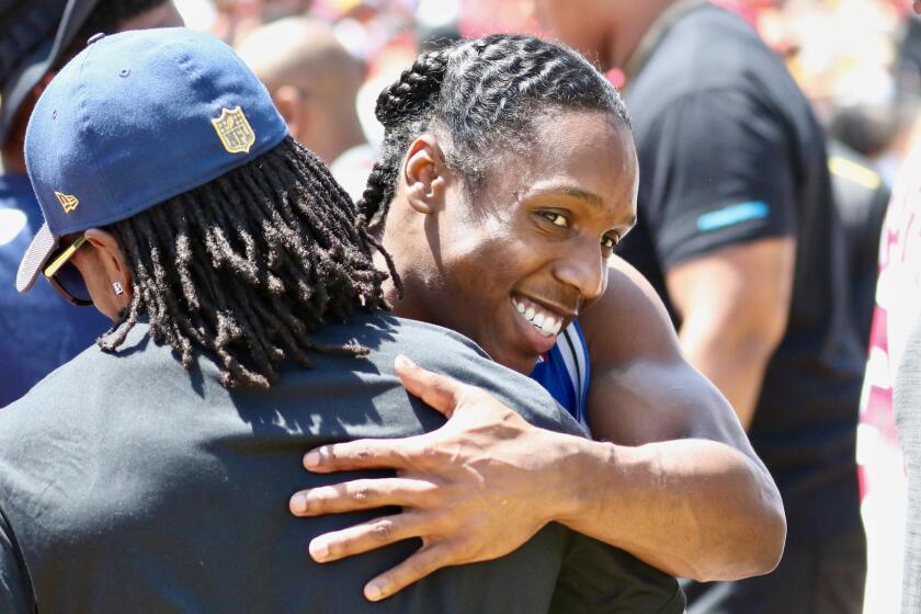 Adoree' Jackson shares a hug with new Rams cornerback Nickell Robey-Coleman during USC's spring game on April 14.
