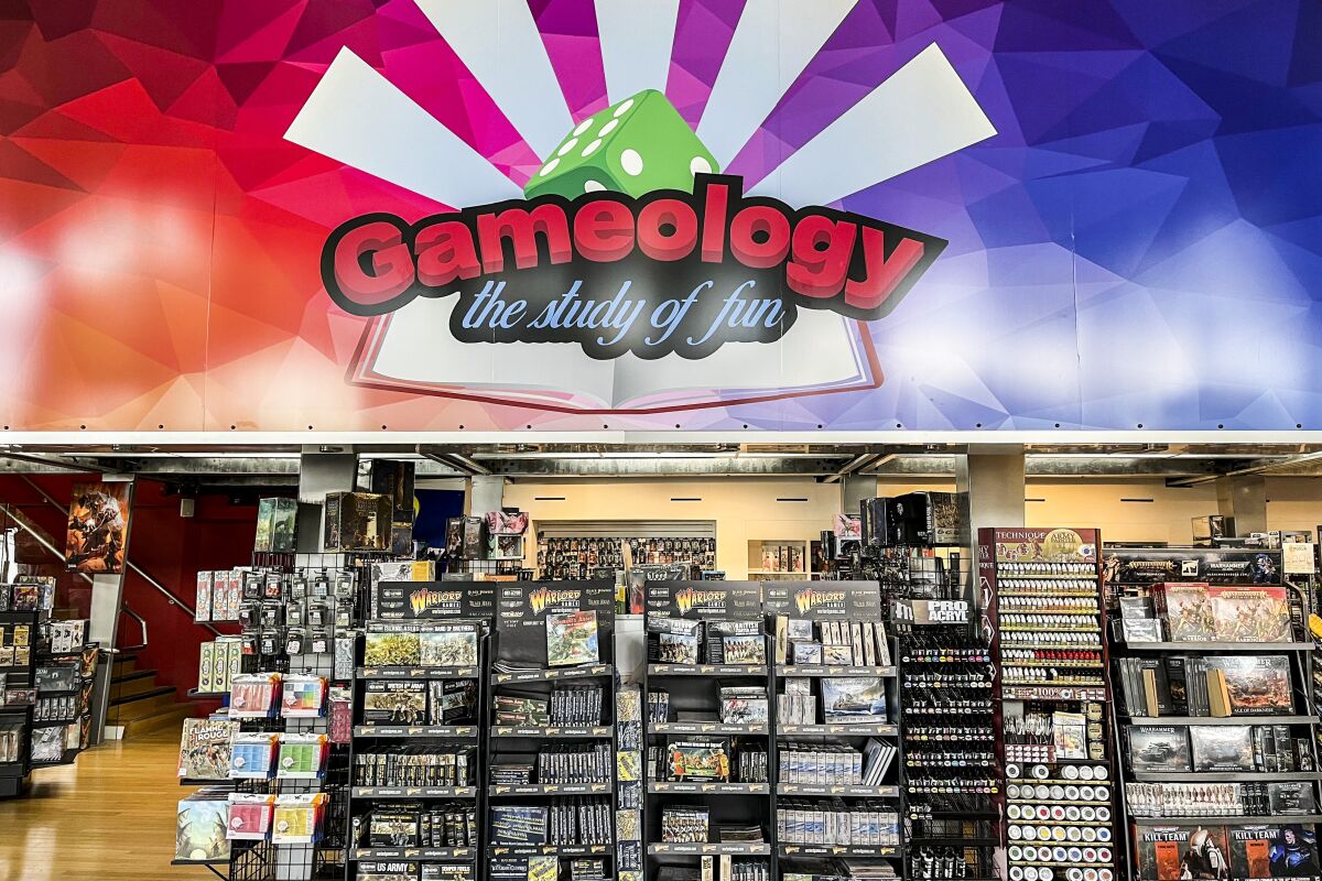 A Gameology banner that reads "the study of fun" hangs above games for purchase inside the store.