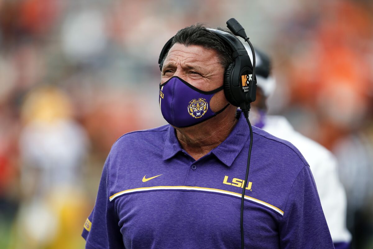 LSU head coach Ed Orgeron walks the sideline during the first quarter of an NCAA college football game against Auburn on Saturday, Oct. 31, 2020, in Auburn, Ala. (AP Photo/Butch Dill)
