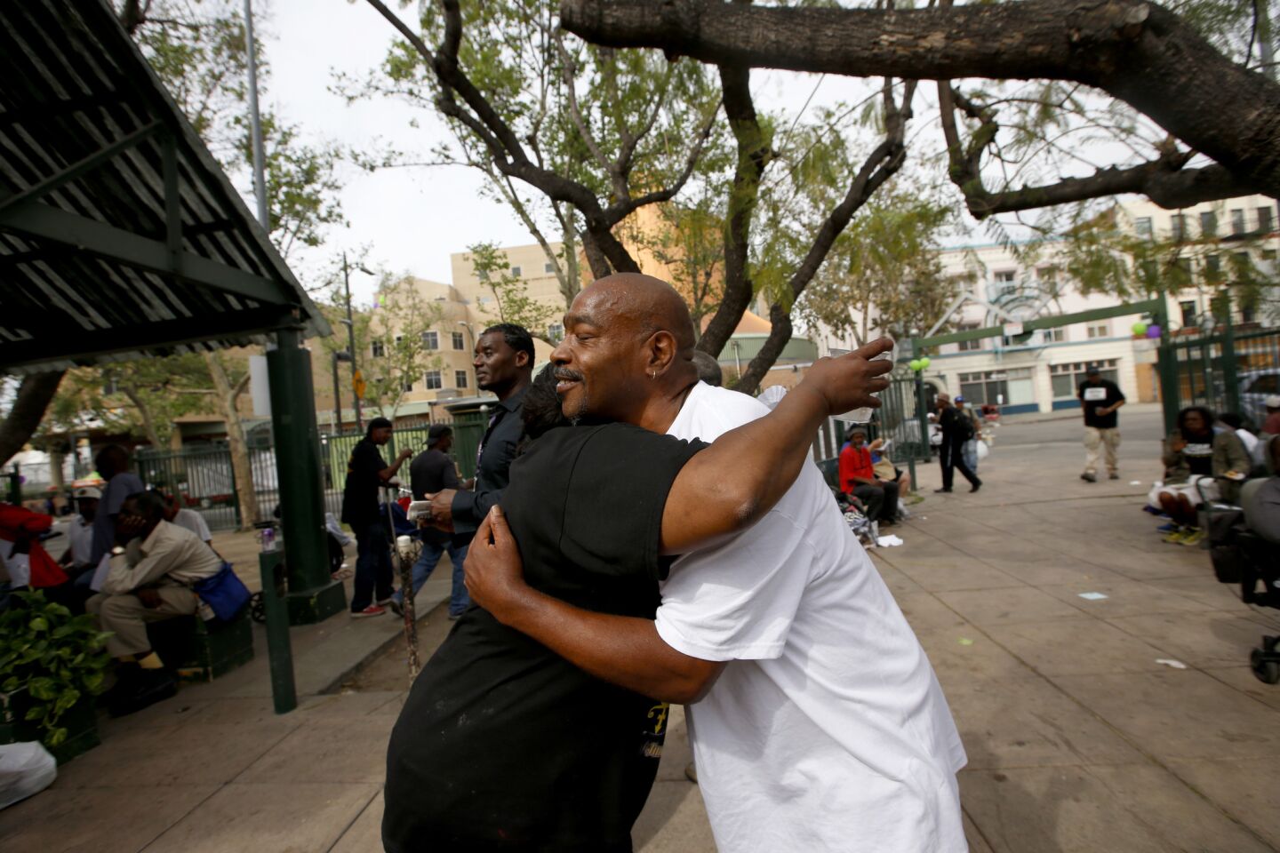 Cocoa Sherry Write, left, and Twin Skid Row, right, hug in San Julian Park in Los Angeles' skid row.