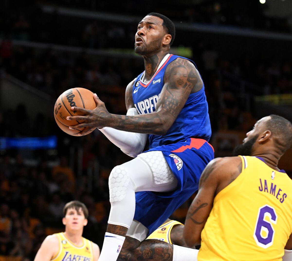 Clippers guard John Wall drives through the Lakers defense to score.