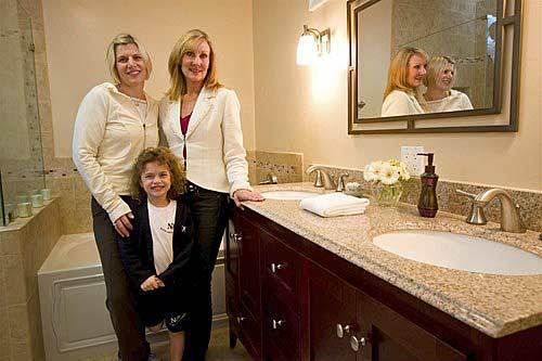 Los Angeles homeowner Meg Moreta, left, her daughter Madeline, 5, and designer Lisa Tanner show off Moreta's new master bathroom, which was gutted and redone in nine days. One of Moreta's chief goals was to remodel her bath with the least amount of stress. To do so, the designer first studied photos of bathrooms Moreta liked, then brought samples of wood, counters, knobs, etc., to the house so Meg could make selections.