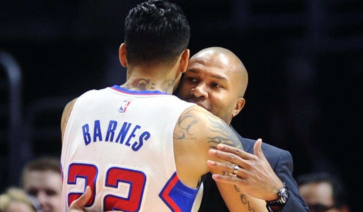 Clippers forward Matt Barnes embraces Knicks Coach Derek Fisher before their game on Dec. 31, 2014.