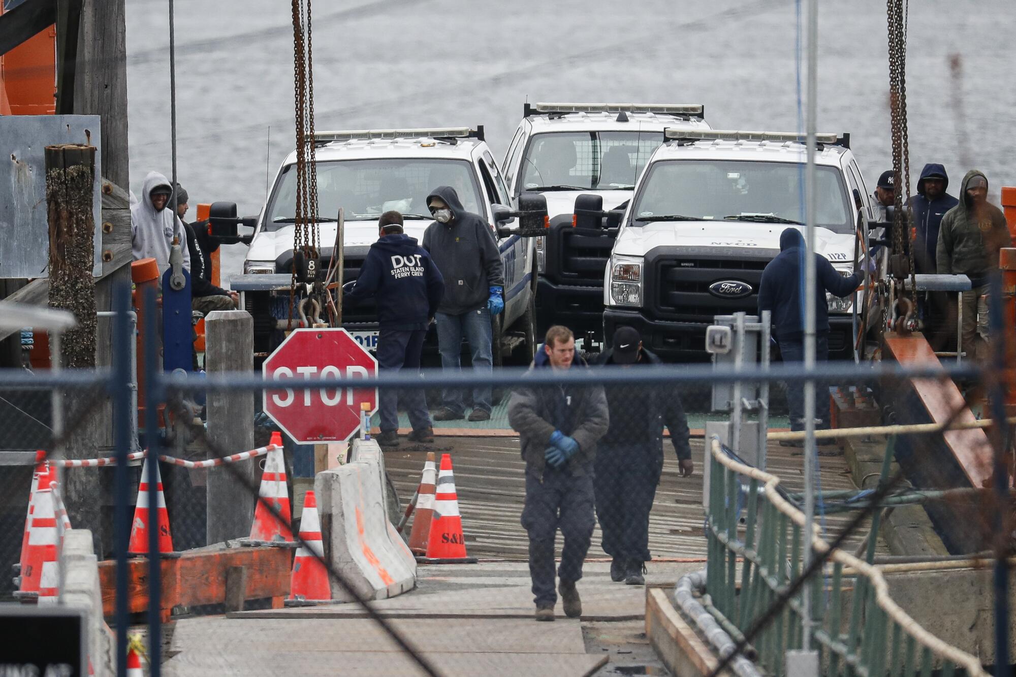 Workers arrive at a dock after leaving Hart Island.