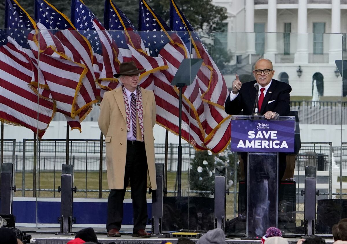 Chapman University professor John Eastman stands next to Rudy Giuliani during a rally near the White House.