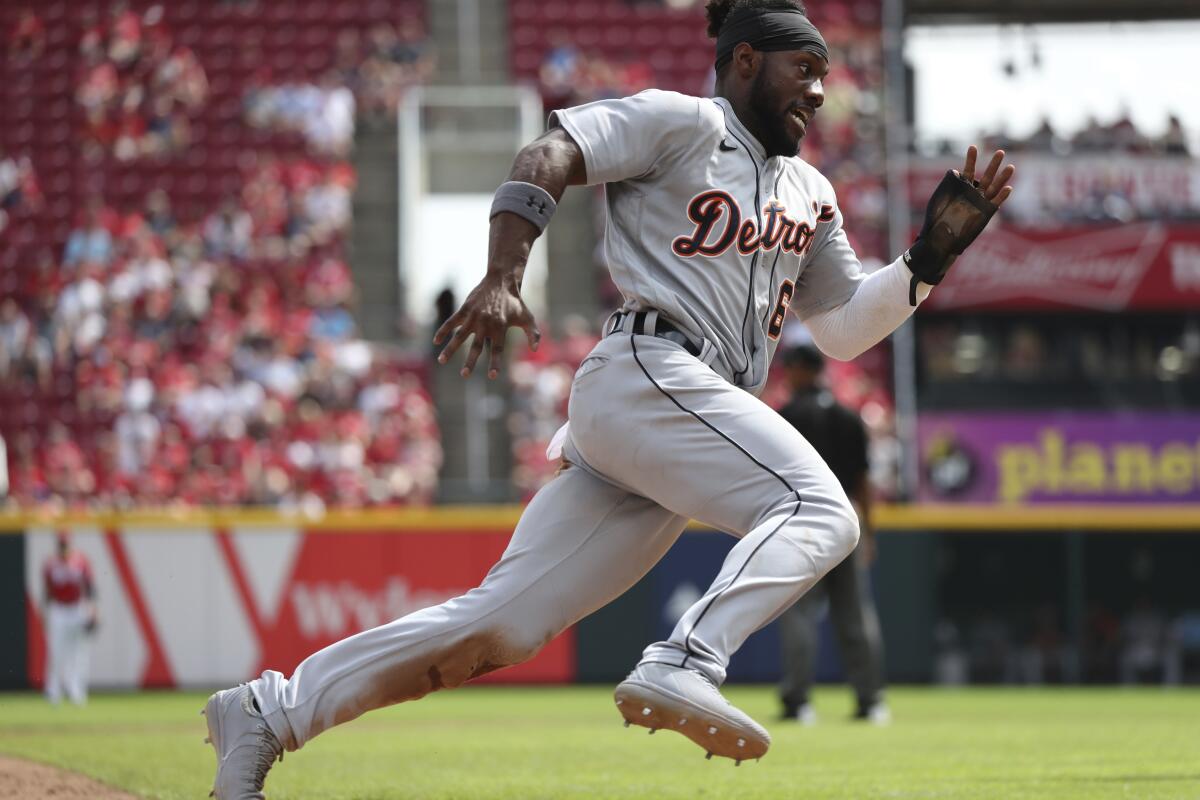 Detroit Tigers baserunner Akil Baddoo (60) rounds third on his way to scoring on a ball off the bat of Jonathan Schoop during the eighth inning of a baseball game, Sunday, Sept. 5, 2021, in Cincinnati. (AP Photo/Gary Landers)