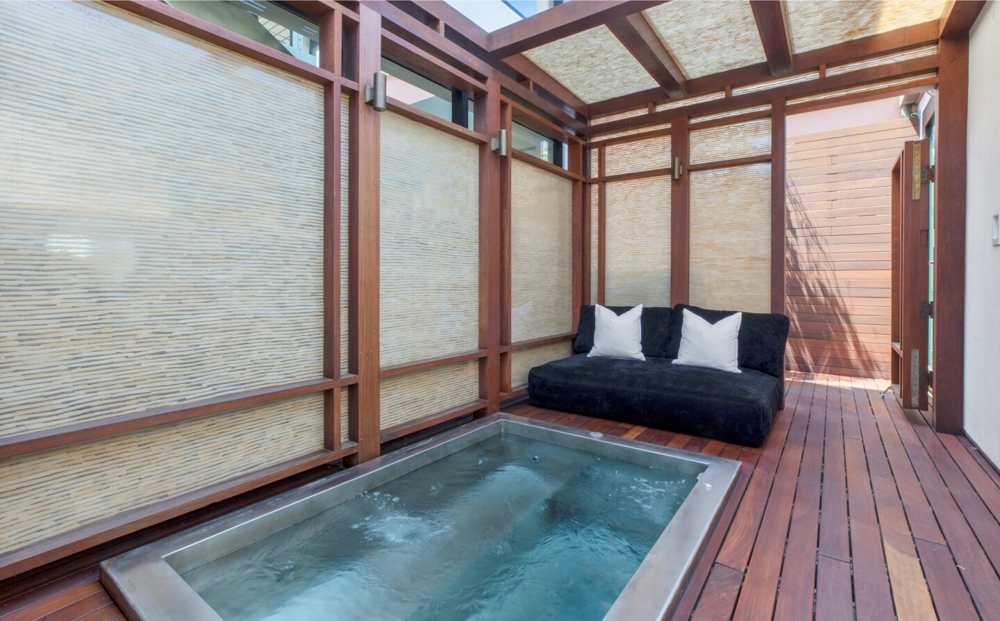 The architectural beach house expands to two levels of wood decks overlooking the ocean.