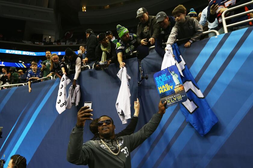 Running back Christine Michael of the Seattle Seahawks interacts with fans during Super Bowl XLVIII Media Day at the Prudential Center on Jan. 28 in Newark, New Jersey. Super Bowl XLVIII will be played between the Seattle Seahawks and the Denver Broncos on Feb. 2.