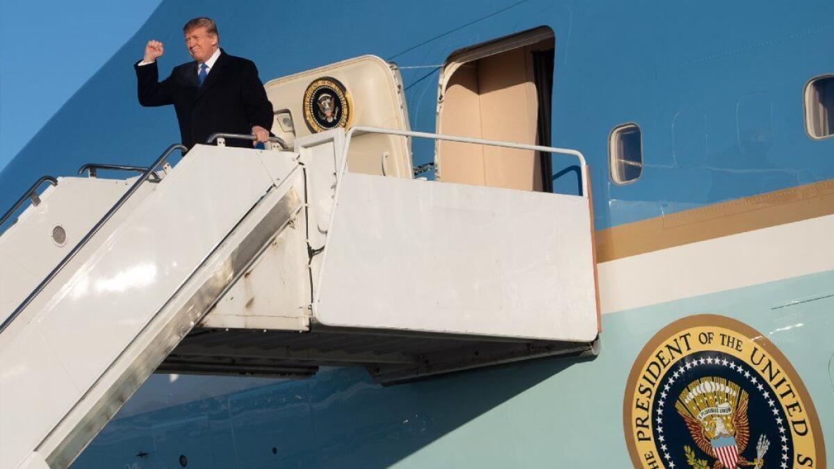 President Trump disembarks Air Force One during a refueling in Alaska on his way back to Washington from a summit with North Korea's Kim Jong Un.