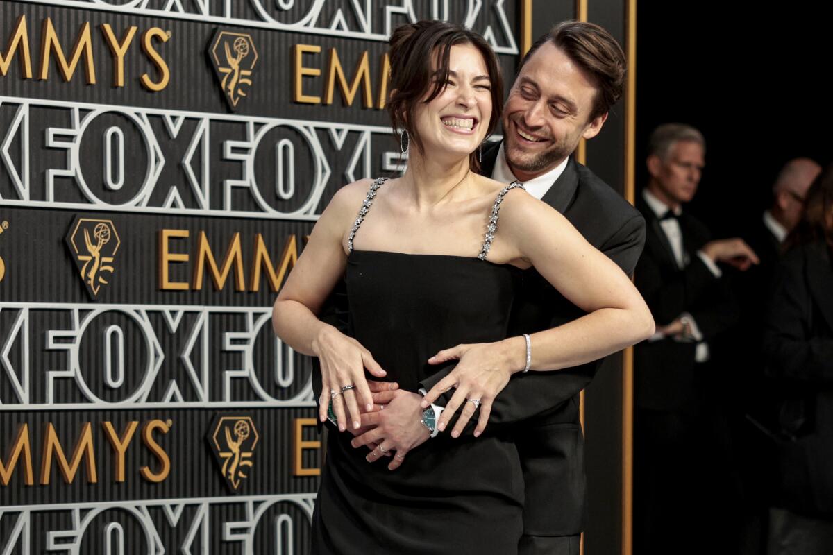 Kieran Culkin hugs his wife Jazz Charton on the Emmys silver carpet
