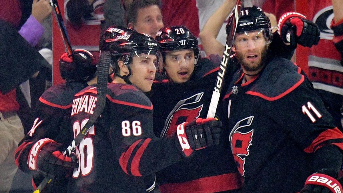 Sebastian Aho (20) of the Carolina Hurricanes celebrates after scoring against the New York Islanders in the first period.