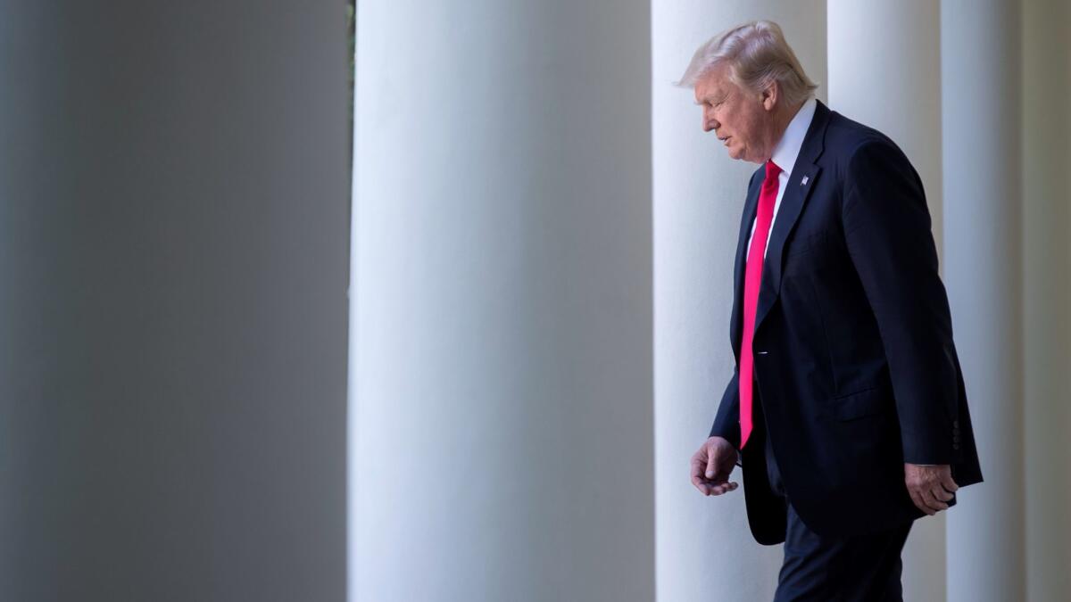 President Donald Trump walks from the Oval Office to announce that the US is withdrawing from the Paris climate accord in Washington on June 1.