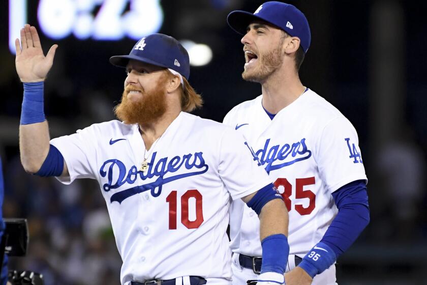 Los Angeles, CA - October 19: Los Angeles Dodgers' Justin Turner, left, and Cody Bellinger celebrate.