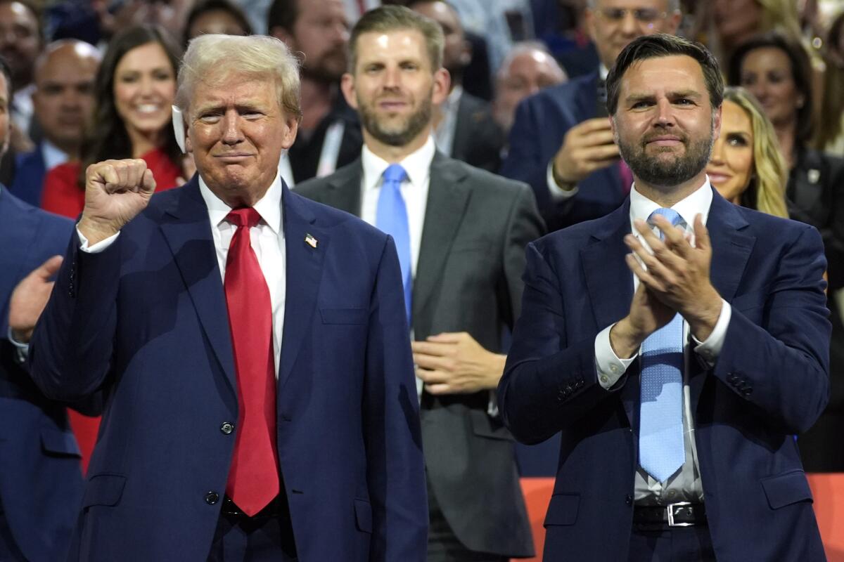 Former President Trump and Republican vice presidential candidate Sen. JD Vance with a crowd behind them 