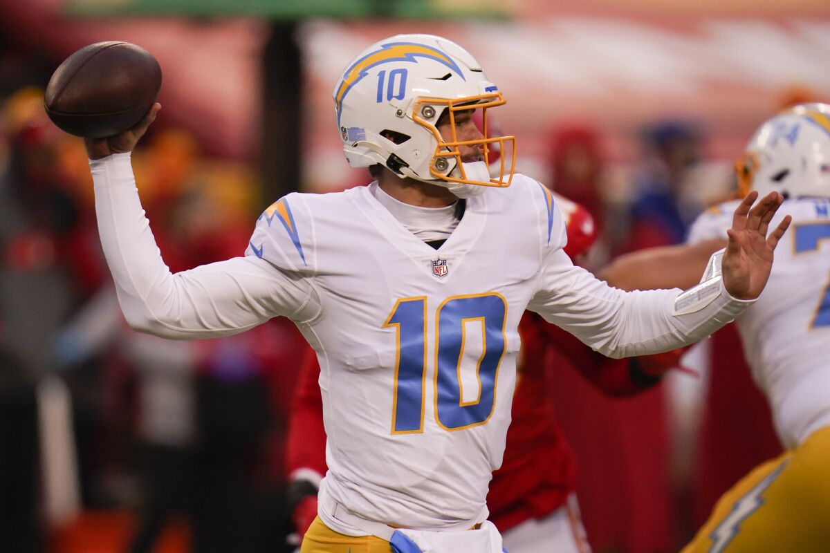 Los Angeles Chargers quarterback Justin Herbert throws a pass during the first half of an NFL football game against the Kansas City Chiefs, Sunday, Jan. 3, 2021, in Kansas City. (AP Photo/Jeff Roberson)