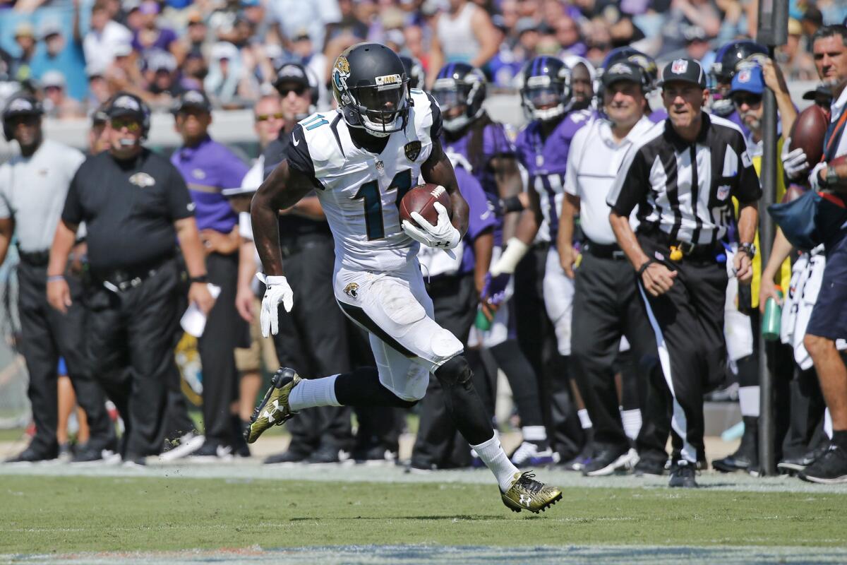 Jaguars receiver Marqise Lee (11) runs with the ball after catching a pass against the Baltimore Ravens on Sept. 25.