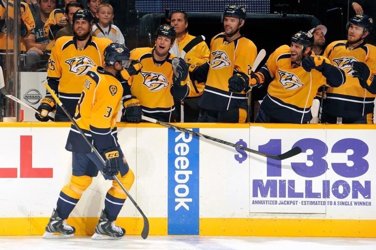 Seth Jones of the Nashville Predators is congratulated by teammates after scoring his first goal in the NHL, against the New York Islanders on Oct. 12.