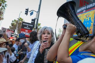 Hollywood, CA - June 29: Actress and activist Jane Fonda speaks during a "Striking 9 to 5" picket line in front of Netflix headquarters, in Hollywood, CA, Thursday, June 29, 2023. Fonda was joined by her 1980 workplace comedy film co-star Lily Tomlin, as well as screenwriter Patricia Resnick, and all spoke in support of writers and their 59th day of striking. (Jay L. Clendenin / Los Angeles Times)