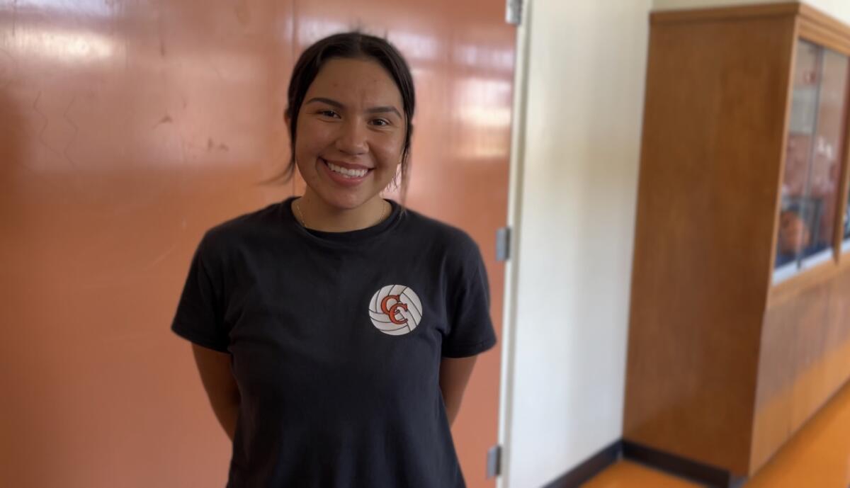 Geraldine Martinez smiles in a hallway at school.