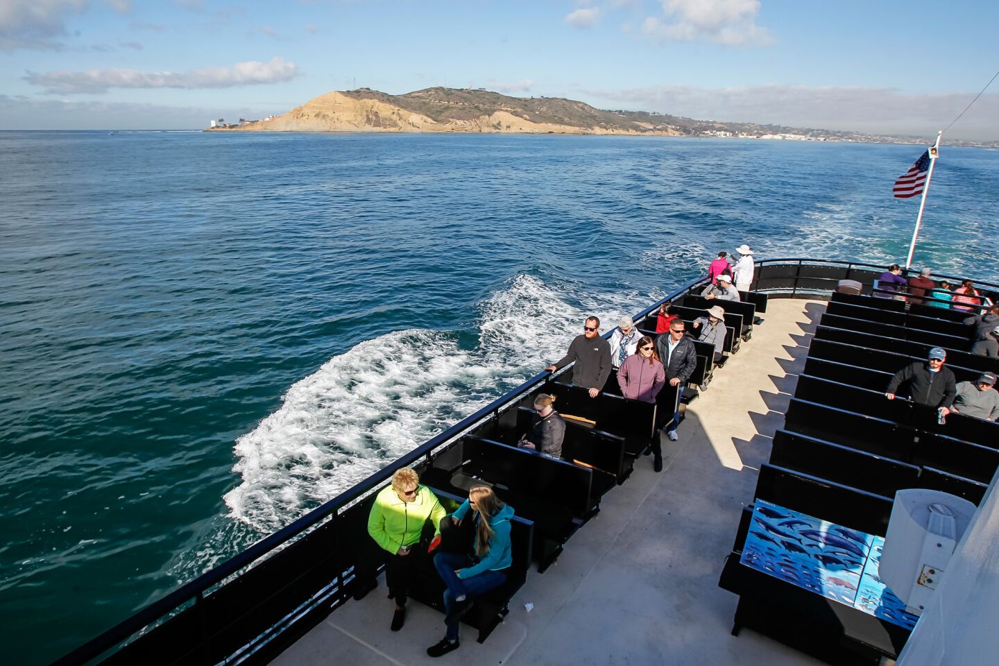 Passengers aboard the Marietta enjoy views off Point Loma as they leave on a whale watching tour.