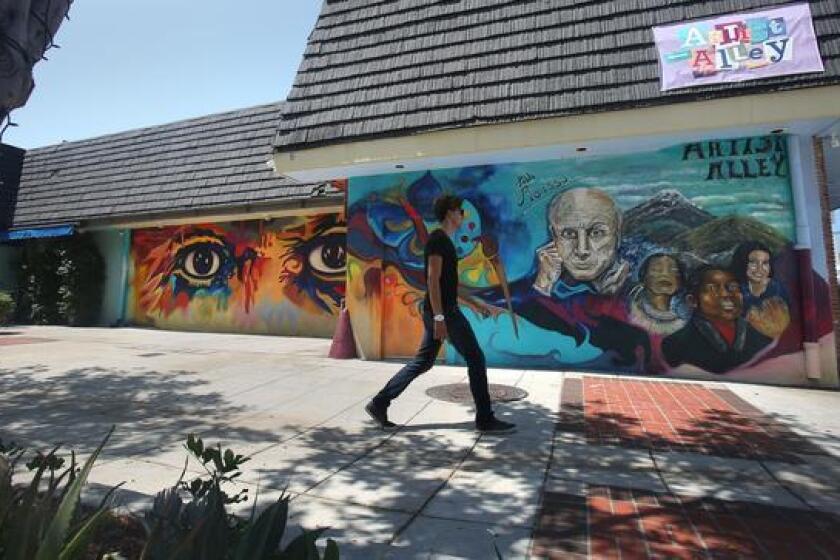 One of the city's newest murals, called Ojos de Picasso, left, by San Diego muralist Mario Torero, is in Artist Alley across the street from city hall behind the Breakfast Club Diner in Oceanside.