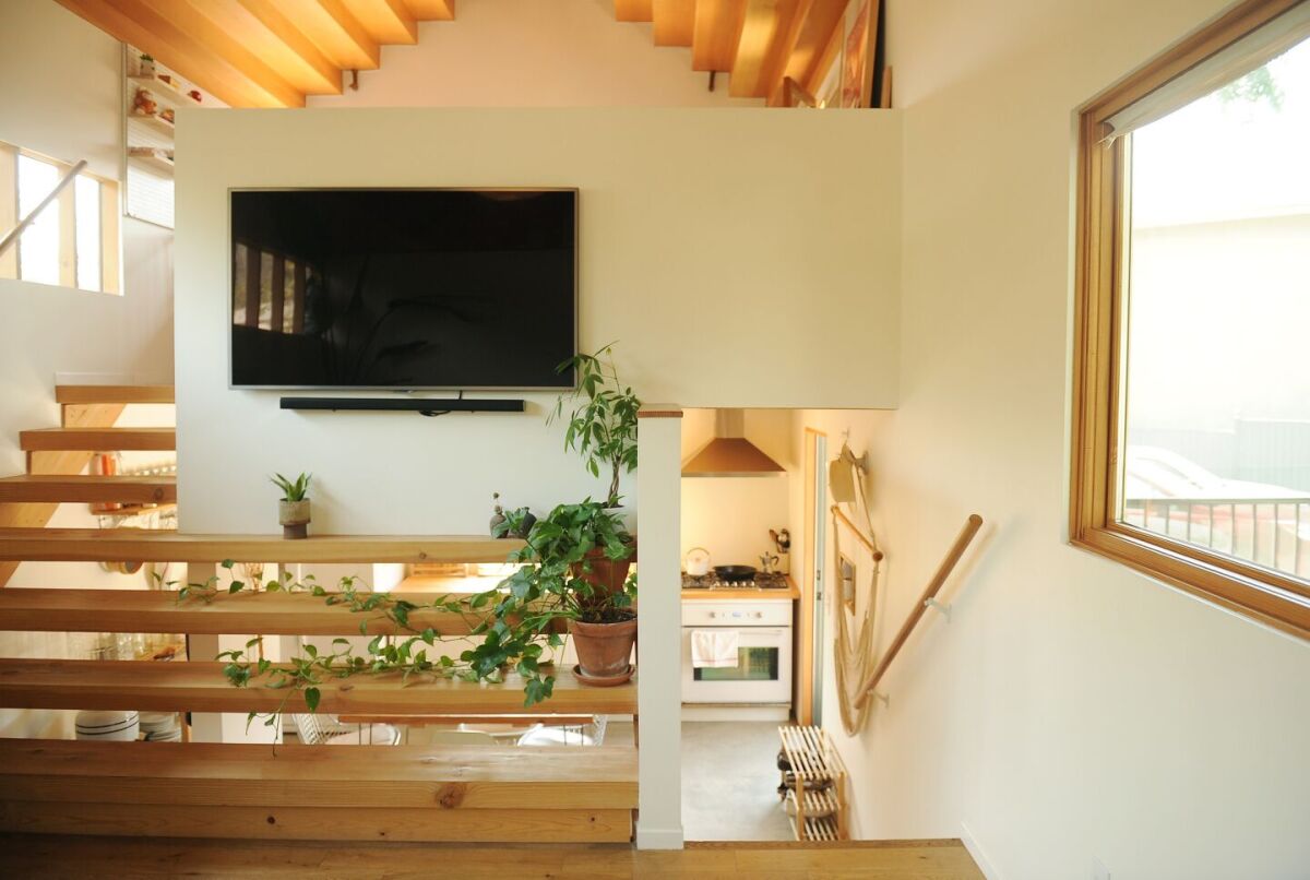 View of a living room, staircase and kitchen of an ADU