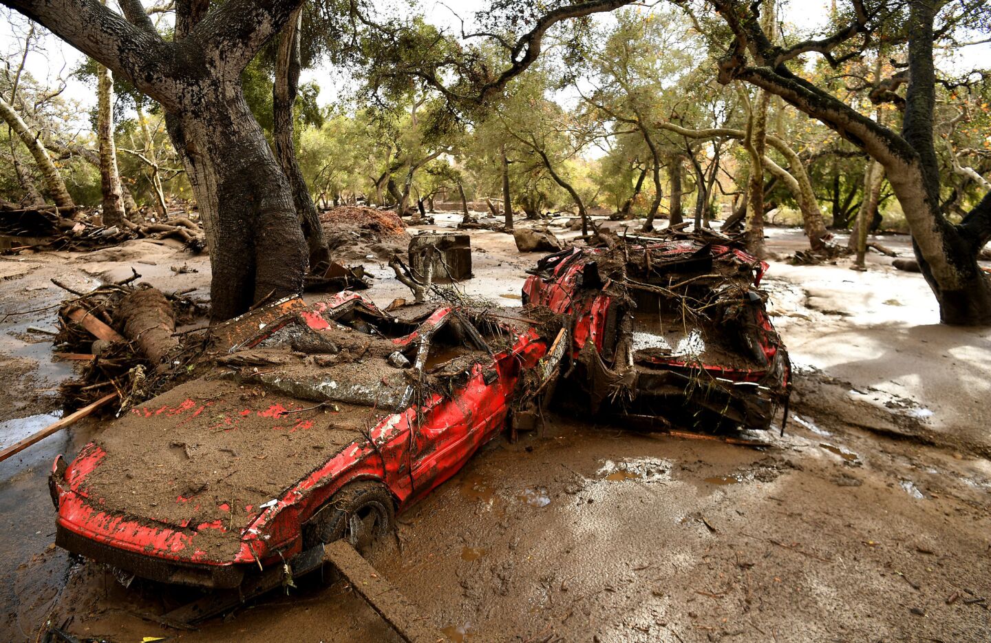 Mangled cars are stuck near Olive Mill Road in Montecito after a major storm hit the burn area Tuesday.