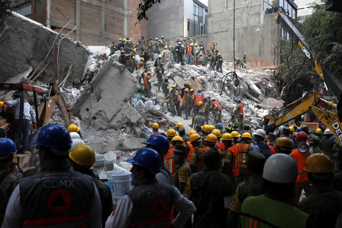 Search and rescue teams remove rubble and look for people in a collapsed six-story residential building in Mexico City.