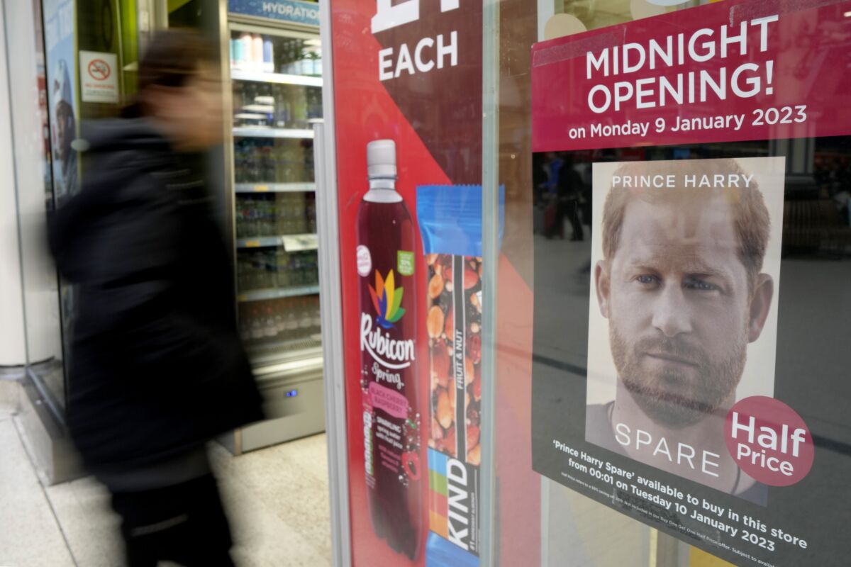 A poster advertises the midnight opening of a store to sell Prince Harry's memoir