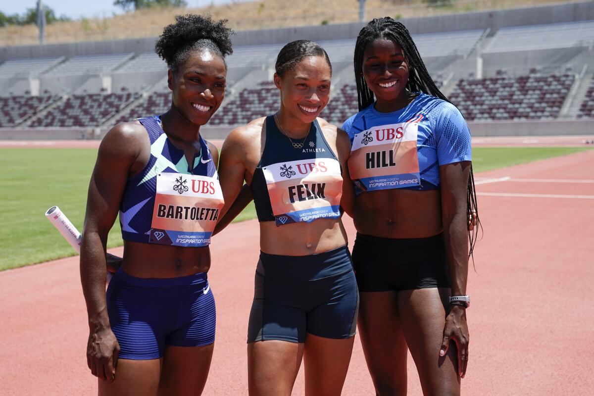 Americans Tianna Bartoletta, Allyson Felix and Candace Hill celebrate after winning the women's 3x100-meter relay.