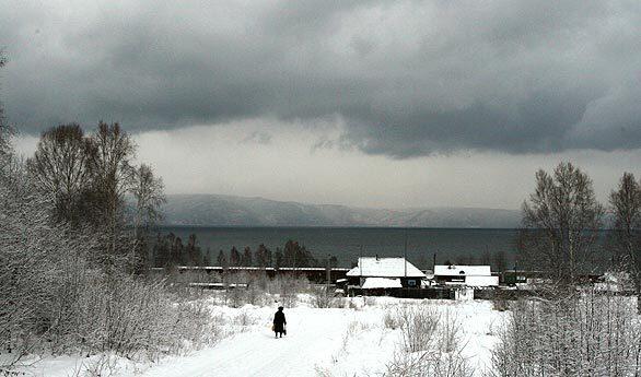 A view of a village along railroad tracks on the shore of Lake Baikal near the town of Baikalsk. The global financial meltdown threatens to drive the lonesome town of Baikalsk, which also clings to the lakeshore in the great wastes of Siberia, into extinction.