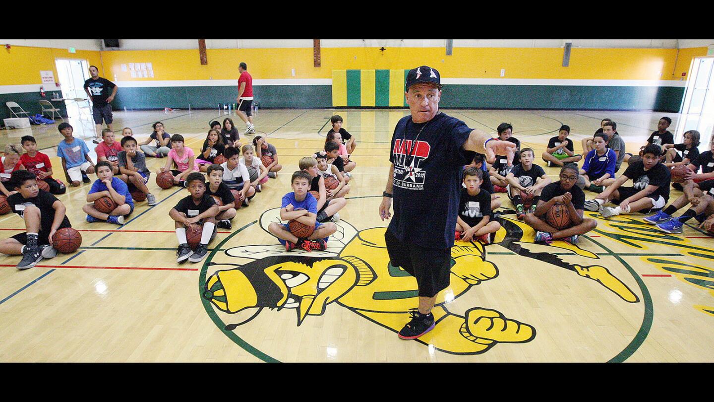 Camp director Mike Graceffo demonstrates to his campers how a basketball team positions itself on a basketball court at the 17th annual MVP Summer Basketball Camp at Luther Burbank Middle School on Tuesday, July 25, 2017.