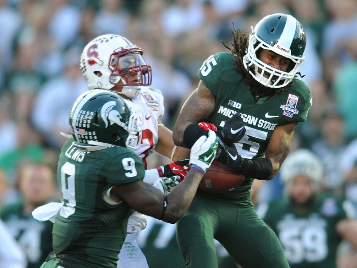 Michigan State cornerback Trae Waynes intercepts a pass in front of Stanford receiver Michael Rector during the Rose Bowl on January 1, 2014.