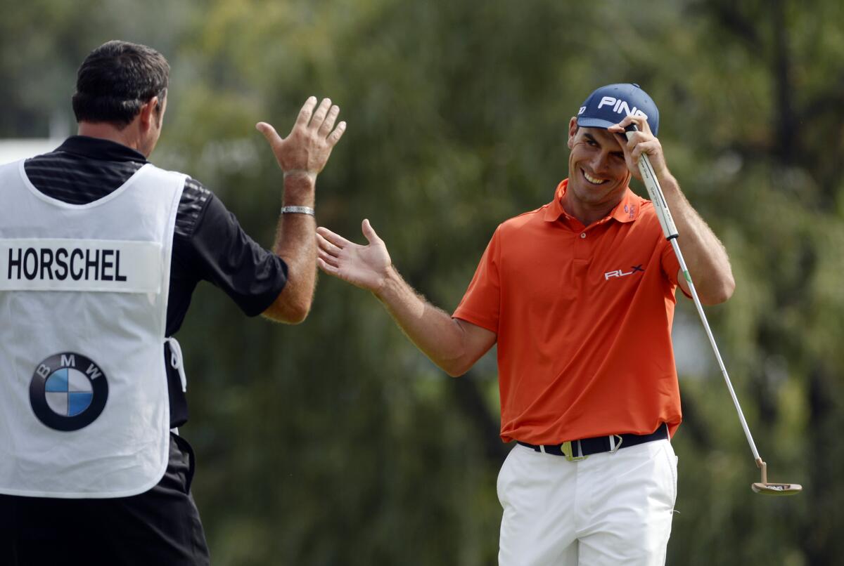 Billy Horschel celebrates withhis caddie after completing the third round of the BMW Championship on Saturday.