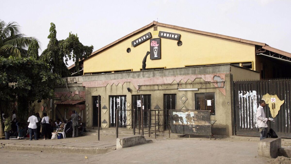 People hang out outside the new Africa Shrine, a music venue built and owned by Femi Kuti, a son of the Afro-beat legend Fela Kuti, on May 28, 2009, in Lagos, Nigerla.