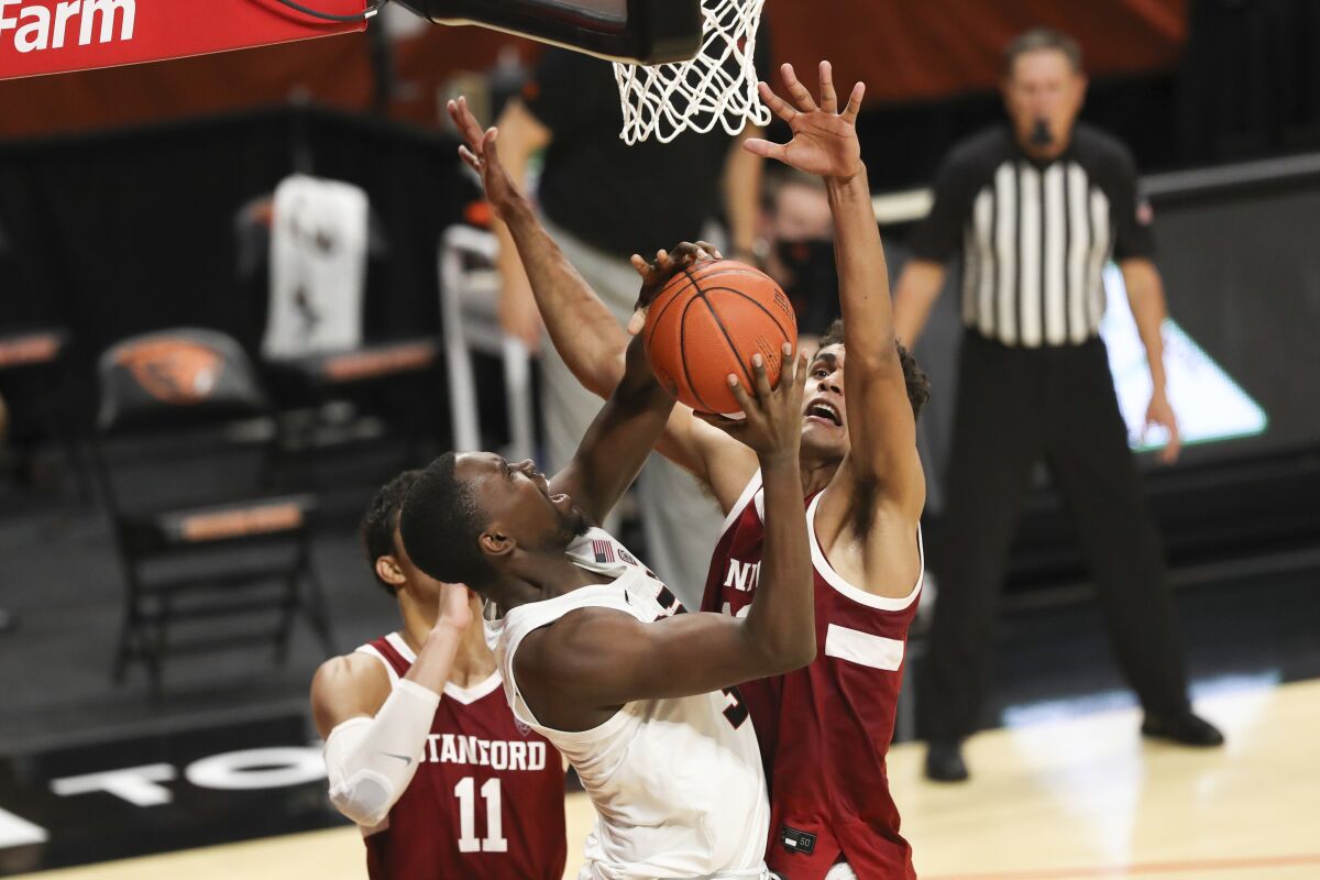 Stanford's Oscar da Silva blocks a shot by Oregon State's Dearon Tucker.