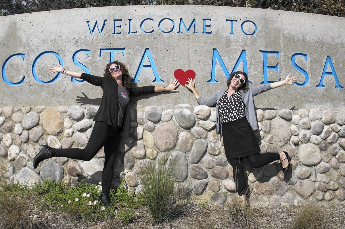 Brandy Young, left, and Erin Huffstutter have started a new online magazine called I Heart Costa Mesa. “We explore and adore the city,” Huffstutter says. “But the adore is a huge part of what we do.”
